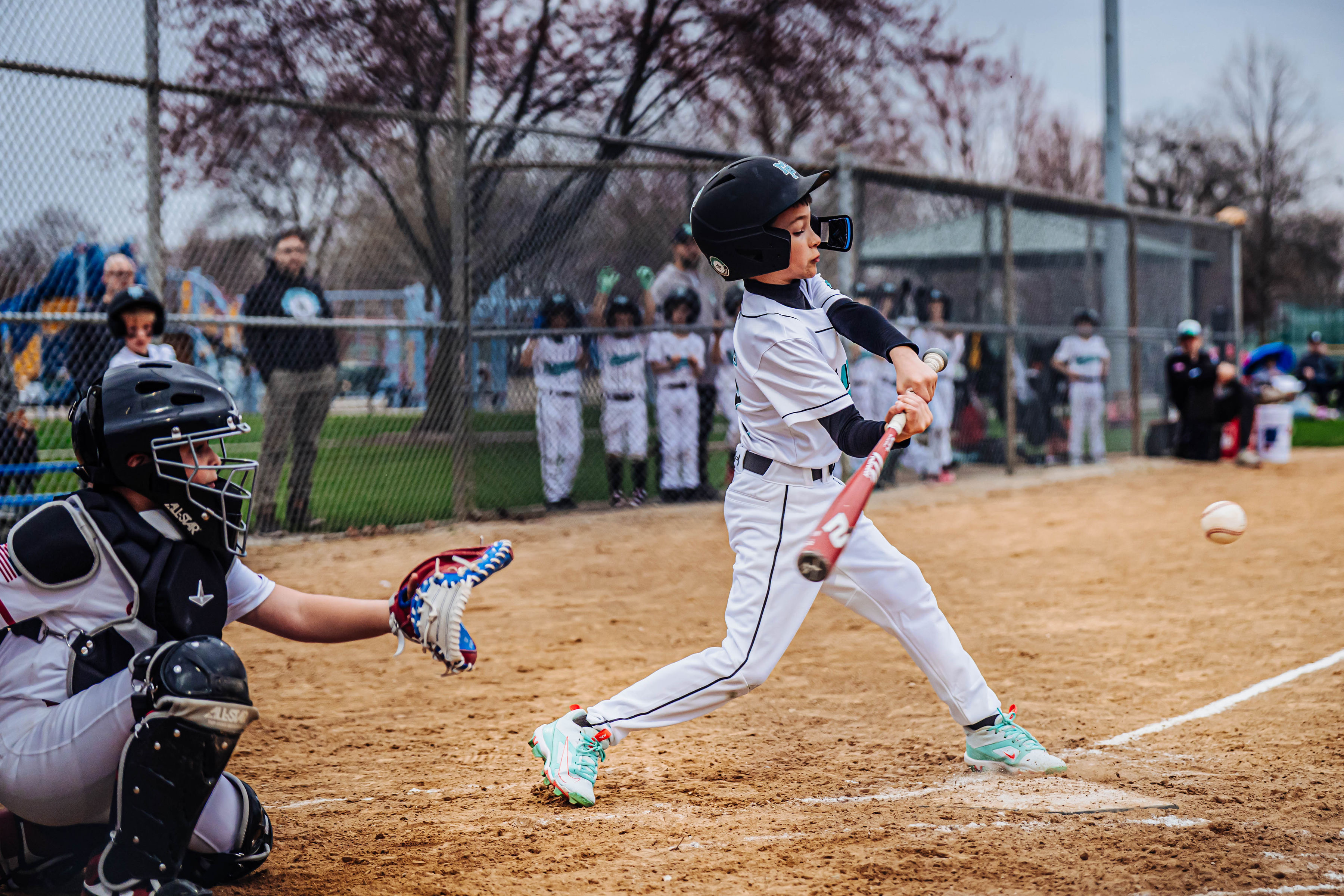 Mavs batter making contact, full follow-through swing