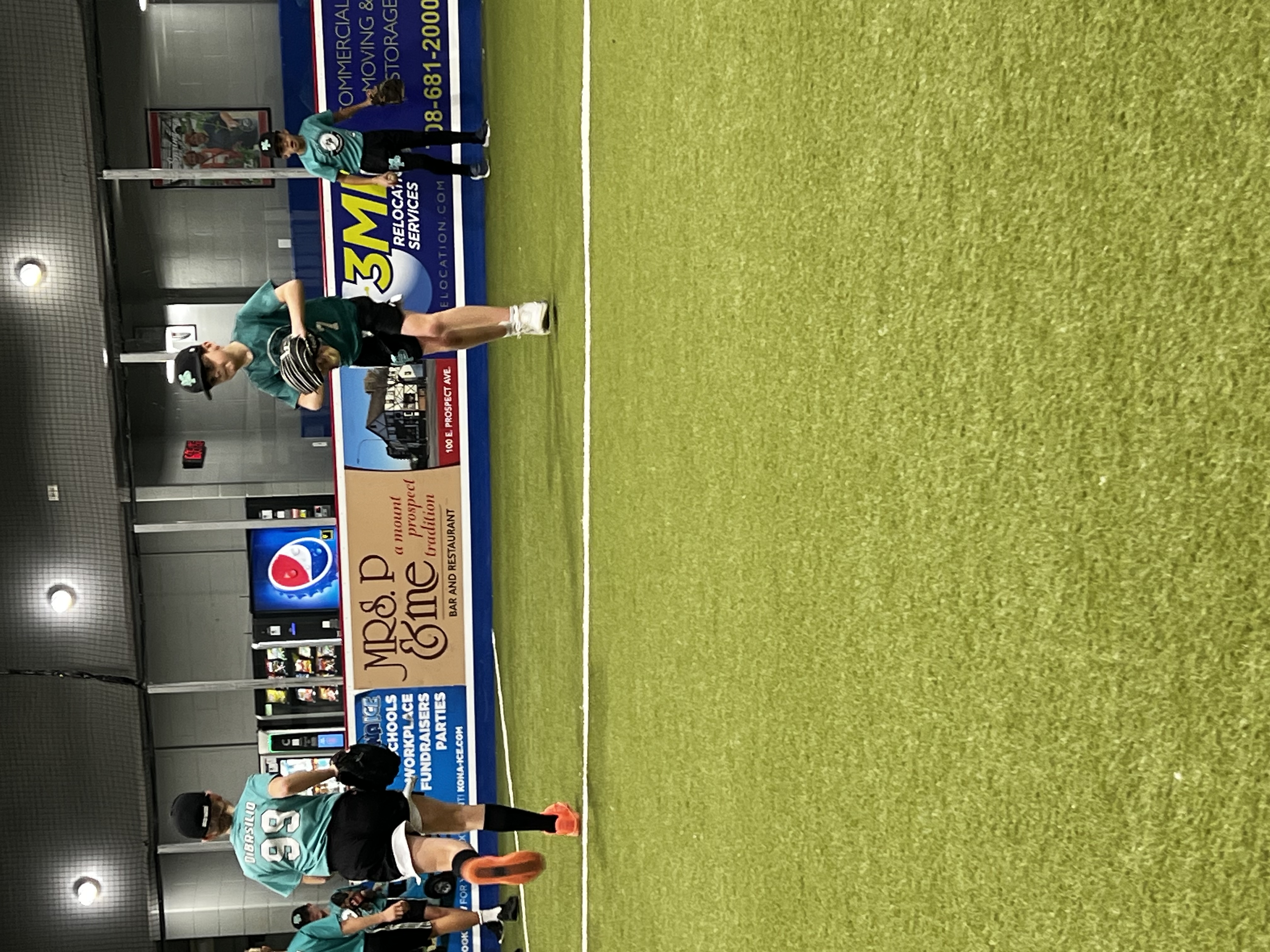 Mavericks at indoor practice with sponsor banners