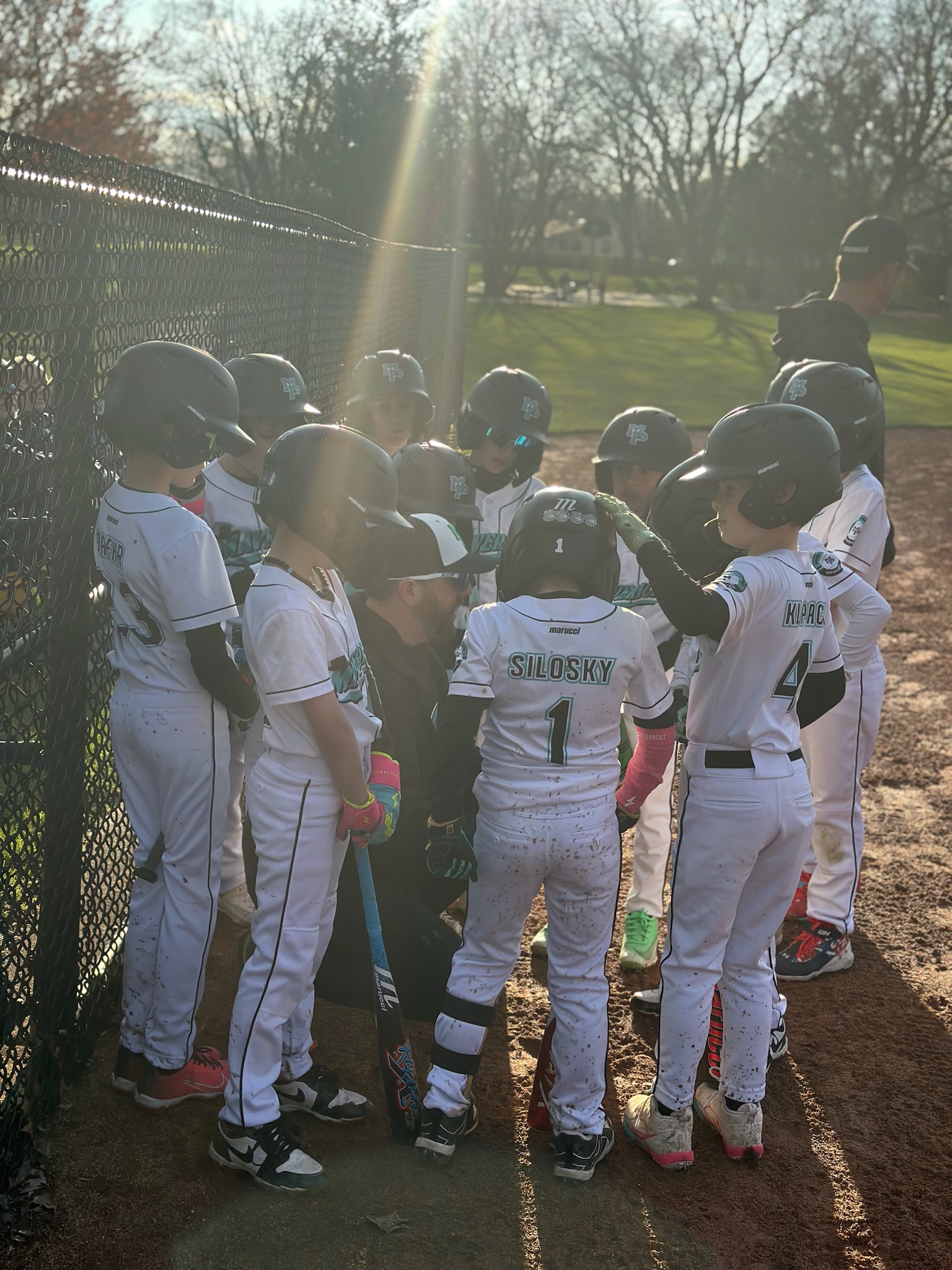 Young Mavs in a pregame huddle with sun streaming through