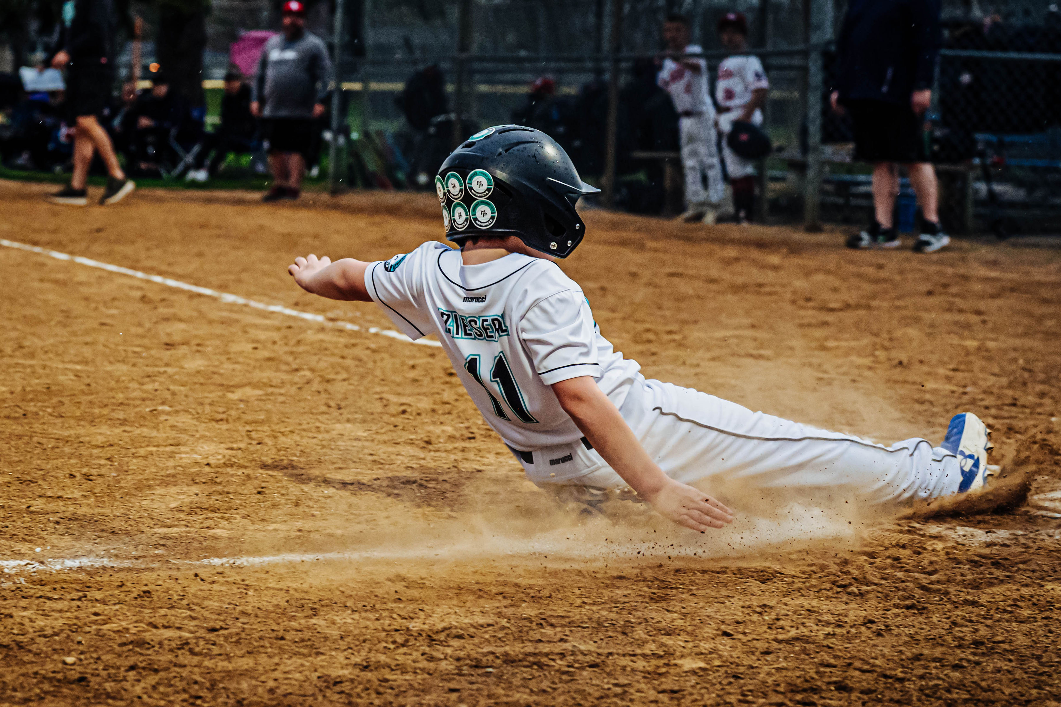 Zieserl #11 sliding into home, dust flying